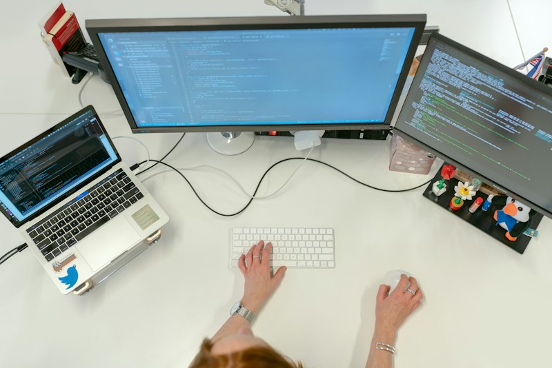 Developer working across multiple monitors